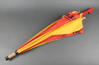 A Ferrari red and yellow cloth umbrella with bamboo sticks and wooden handle 