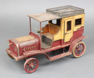 A Bing 1910 tinplate Georg Carette Reise Limousine model toy car with Bing mark to the base, the body is in good overall condition with possibly one headlamp missing, the paint is flaking all over and requires restoration, there is no chauffeur