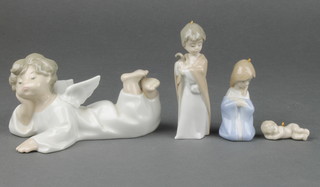 A Lladro figure of a reclining Angel 6", 3 ditto crib Christmas tree decorations 