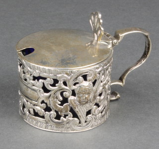 A Victorian pierced repousse silver circular mustard with blue glass liner, London 1895, 74 grams 