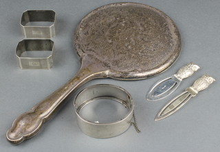 2 silver napkin rings, 2 silver book marks, a bangle and a silver backed hand mirror, weighable silver 81 grams 