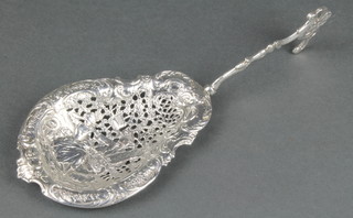 A Victorian Continental pierced silver serving spoon with fancy handle and fete gallant scene, London import marks 1897, 75 grams 