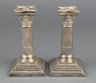 A pair of dwarf silver plated Corinthian column candlesticks on stepped bases 4" 
