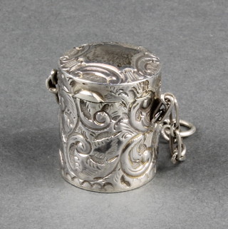 A Victorian silver repousse thimble holder with lid and chain containing a later thimble 