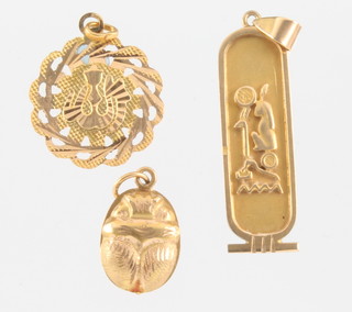 An Egyptian high carat pendant, a ditto scarab pendant and a pierced pendant 7.5 grams