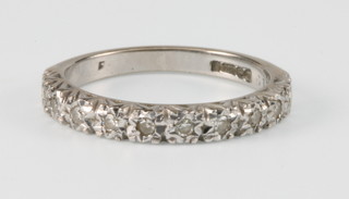 An 18ct white gold diamond half eternity ring, size K 1/2