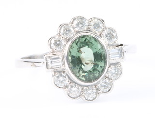 An 18ct white gold green sapphire and diamond cluster ring, size P 1/2