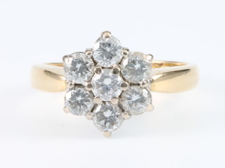 An 18ct yellow gold 7 stone diamond "daisy" diamond ring, size I 1/2