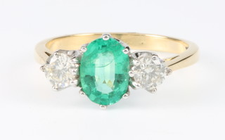 An 18ct yellow gold Victorian style emerald and diamond ring, the centre stone 0.5ct, flanked by single brilliant cut diamonds 0.5ct each, size M 1/2