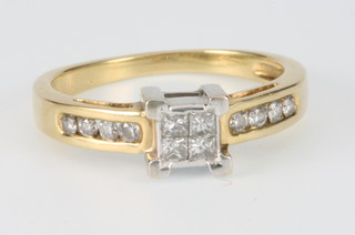 An 18ct yellow gold 4 stone diamond Princess cut ring, the shoulders each with 4 brilliant cut diamonds, size N