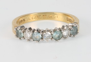 An 18ct yellow gold aquamarine 4 and diamond 3 stone half hoop ring, size K