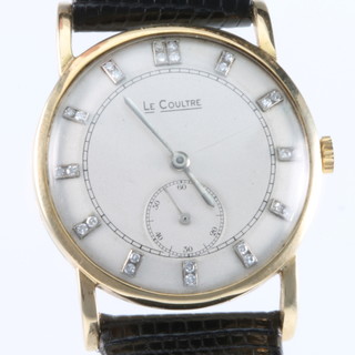 A gentleman's 18ct gold Le Coultre wristwatch with seconds at 6 o'clock and 2 stone diamond batons on a leather bracelet 
