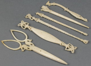 A pair of carved bone scissors, minor sewing implements