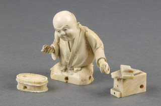 A 19th Century carved Japanese ivory okimono of a seated carpenter 2" 