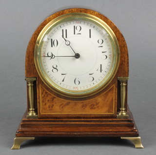 A French bedroom timepiece with enamelled dial and Arabic numerals contained in an arch shaped mahogany and walnut case on gilt bracket feet 