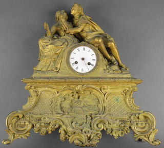 A 19th Century French mantel clock with enamelled dial and Arabic numerals contained in a gilt spelter case surmounted by a figure of a couple 