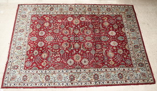 A Persian Tabriz red ground and floral patterned carpet 130" x 92", some wear 