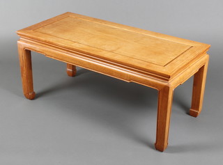 A rectangular bleached Padouk coffee table, raised on square supports 16"h x 36"w x 17"d 