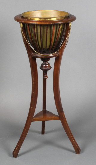 An Edwardian style circular mahogany jardiniere with brass liner, raised on outswept supports with under tier 35"h x 16" diam. 