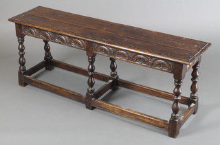 A Victorian rectangular carved oak stool of joined construction, raised on 6 turned and block supports with carved apron 18"h x 48"w x 12"d 