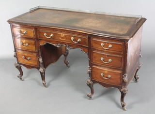 A Victorian Chippendale style mahogany kneehole pedestal desk with brass three-quarter gallery and brown leather writing surface above 1 long and 6 short drawers, raised on carved cabriole supports, heavily carved throughout, 31"h x 54"w x 24"d 
