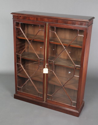 A Victorian mahogany bookcase, the interior fitted adjustable shelves enclosed by astragal glazed panelled doors with brass bevel, raised on a platform base 45"h x 36"w x 11"d 