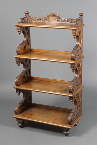 A Victorian rectangular carved oak 4 tier what-not with carved and pierced three-quarter gallery, raised on bun feet 35"h x 25"w x 13"d 