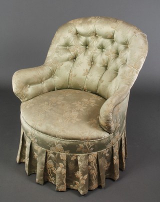 A Victorian wire framed tub back armchair upholstered in green floral buttoned material, raised on turned supports 