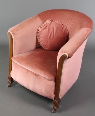 A mahogany show frame tub back armchair upholstered in pink Dralon 