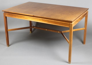 A 1960's G Plan teak dining table with concealed extra leaf, raised on square tapering supports with Y framed stretcher and brass caps to the base of the supports (3 missing) 29"h x 52"l when closed by 78" when fully extended x 34"w 