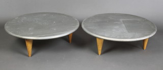Jasper Conran, circa 1997, a pair of stylish circular zinc and teak occasional tables, raised on 3 conical supports 10"h x 32" diam.