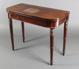 A 19th Century mahogany D shaped card table with inlaid top, raised on ring turned supports 29"h x 35"w x 17"d 