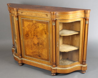 A Victorian figured walnut Credenza of serpentine outline with crossbanded top, having columns to the front and gilt metal embellishments throughout, raised on bun feet 42"h x 63"w x 15 1/2"d  