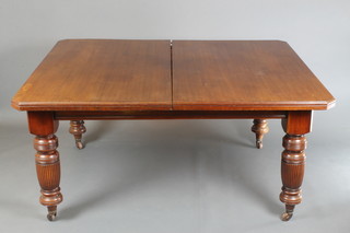 A Victorian mahogany extending dining table with 2 extra leaves, raised on turned and reeded supports 29"h x 59"l x 104" when fully extended x 47"w 