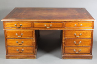 A Victorian mahogany partners desk with brown inset writing surface above 1 long and 14 short drawers, raised on a platform base 31 1/2"h x 67"w x 48"d 