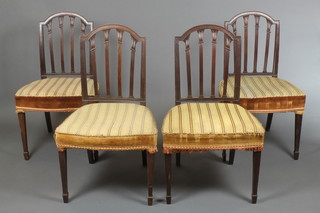 A set of 4 19th Century Hepplewhite style mahogany stick and rail back dining chairs with upholstered seats raised on square tapering supports, spade feet 
