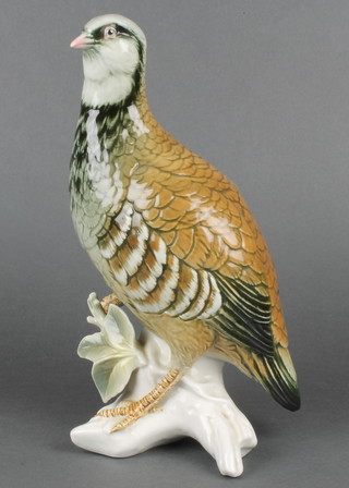 A 20th Century German porcelain figure of a standing grouse on a rocky outcrop 11" 