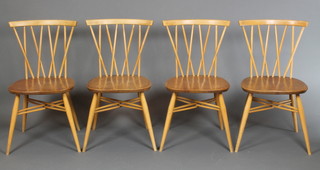 A set of 4 1960's Ercol light elm stick and bar back dining chairs, raised on turned supports with X framed back and stretcher 