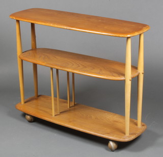 An Ercol oval light elm 3 tier tea trolley, raised on turned supports 27 1/2"h x 36"w x 12"d 