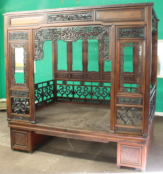 A 19th/20th Century Chinese carved and pierced Padouk opium bed with carved panels throughout 87"h x 89"l x 63"w 