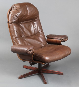 A Swedish Mobler teak framed revolving armchair upholstered in brown hide