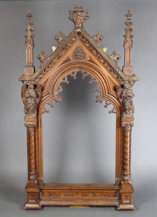 A Victorian carved oak Gothic frame supported by figures of angels 66"h x 37"w x 5"d 