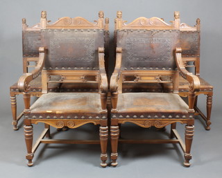 A set of 6 Victorian Continental carved walnut dining chairs the seats and backs upholstered in brown leather with mask decoration, raised on turned supports with H framed stretcher 