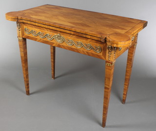 An 18th/19th Century French walnut and kingwood card table with crossbanded top, fitted candle stands and wells, the base fitted 2 candle slides and the interior having an inlaid backgammon board with gilt metal mounts throughout, raised on square tapering supports 31"h x 43 1/2"w x 21 1/2"d 