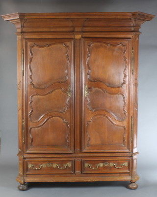 An 18th/19th Century French carved oak armoire with moulded cornice enclosed by panelled doors, the base fitted 2 long drawers 87"h x 76"w x 30"d 