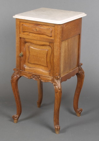 A French 19th Century oak bedside cabinet with white veined marble top, fitted a drawer above a cupboard enclosed by a panelled door, raised on cabriole supports 32"h x 16"w x 16"d 