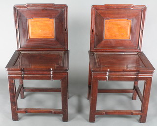 A pair of Chinese Padouk high back chairs raised on turned supports 