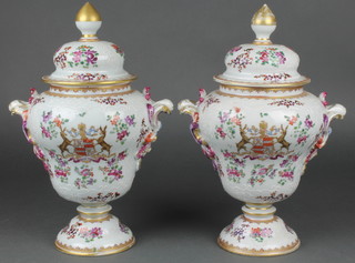 A pair of 19th Century Samson bulbous vases and covers decorated with armorials and flowers  having scroll handles 13"