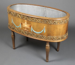 An oval Empire style walnut and gilt mounted planter/wine cooler, the centre painted a lidded urn with gilt metal mounts, raised on turned and fluted supports 23"h x 34"w x 18"d 
