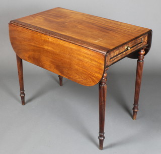 A Regency mahogany Pembroke table with oval flaps, fitted a frieze drawer and raised on turned and reeded supports 28"h x 34"w x 19" when closed x 38" when open 